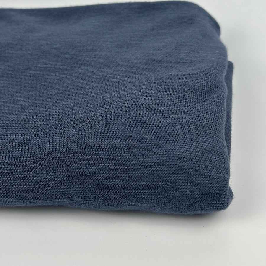 Folded blue cotton modal slub jersey fabric, close up of the knit