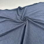 Blue cotton modal slub jersey fabric, swirled to show the drape and slub texture