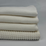 Cotton thermal waffle knit fabric by the yard, four weights stacked from light thermal to heavy waffle