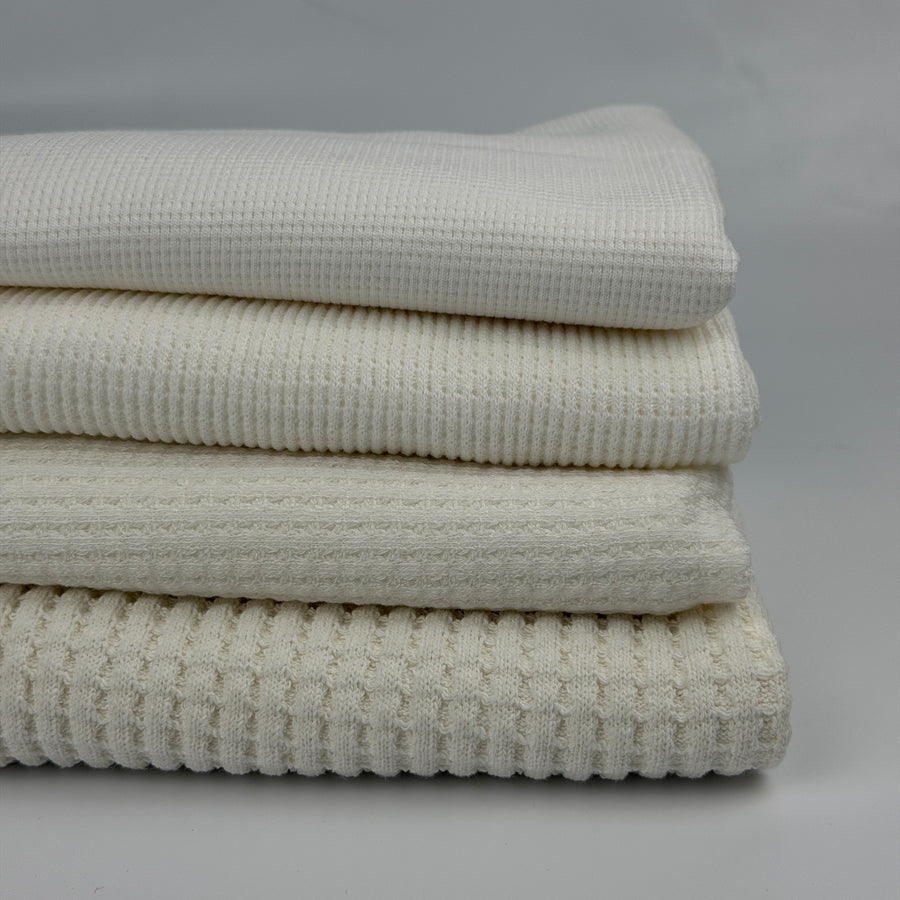 Cotton thermal waffle knit fabric by the yard, four weights stacked from light thermal to heavy waffle