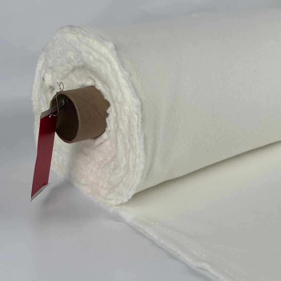 Roll of brushed cotton fleece, PFD natural white, showing the brushed loft at the edge