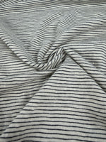 Navy pinstripe slub jersey draped, showing the slub texture