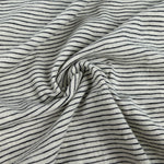 Cotton slub jersey with fine navy pinstripes on a natural ground, swirled