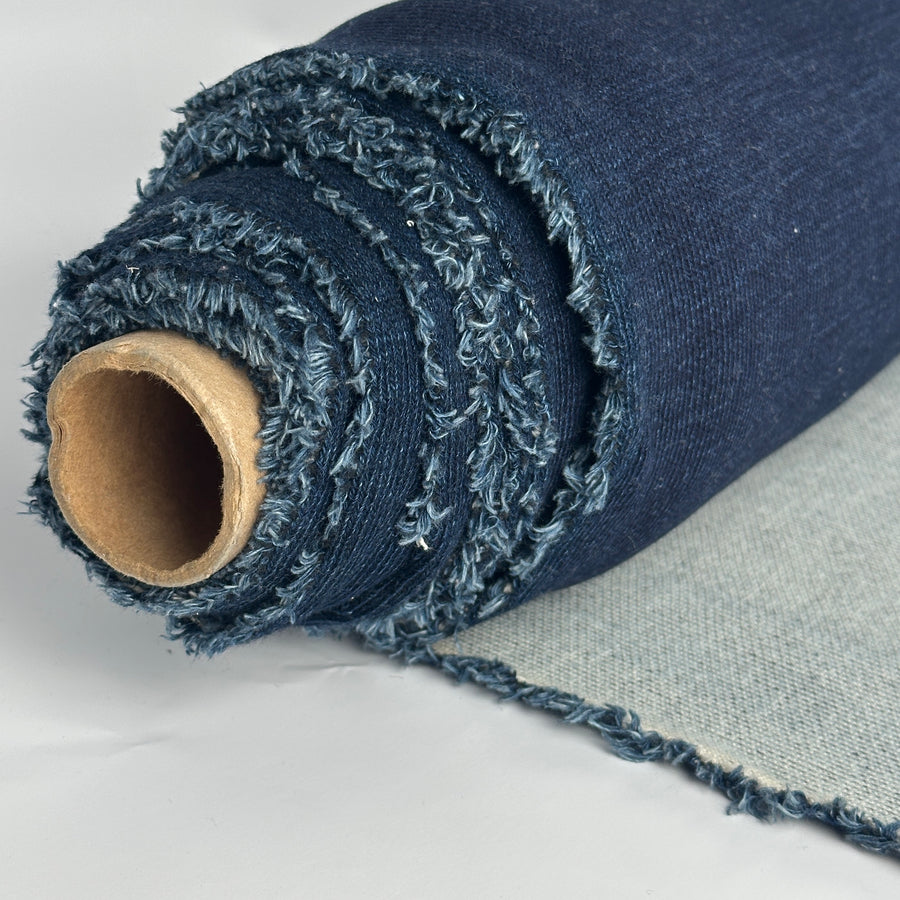 Roll of indigo cotton double knit with light gray back