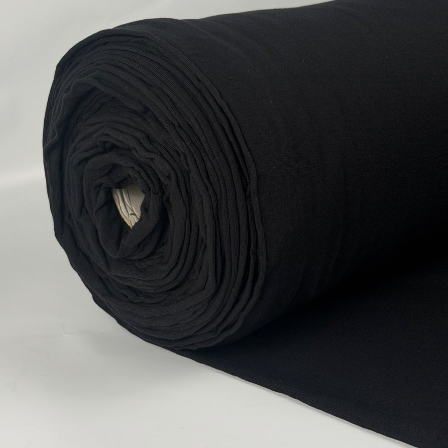 Roll of black organic cotton jersey knit fabric, 193 GSM