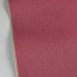 Pink denim twill close-up with red ID selvedge