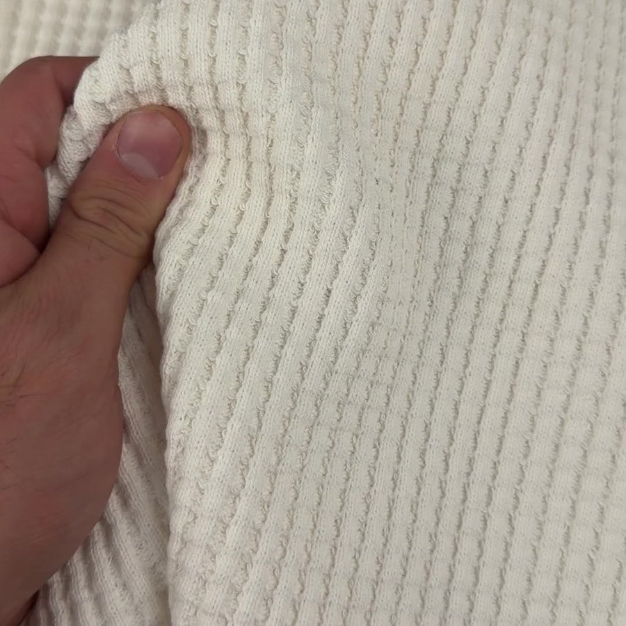 660 GSM extra heavy open-end cotton waffle knit fabric handled to show thickness